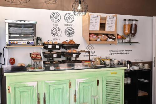a bakery with green doors and pastries on a counter at HB Torrevieja in Torrevieja