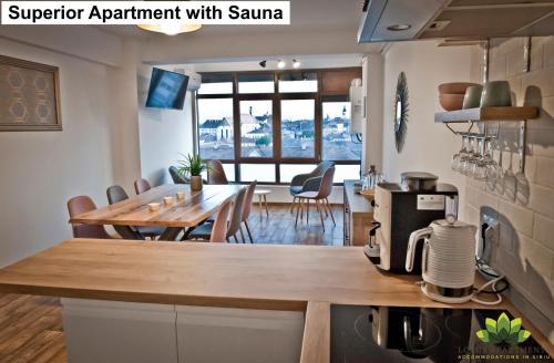 a kitchen and living room with a table and a dining room at Sibiu Lotus Apartments in Sibiu