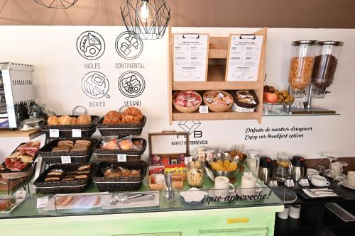 a bakery counter with various types of bread and pastries at HB Torrevieja in Torrevieja
