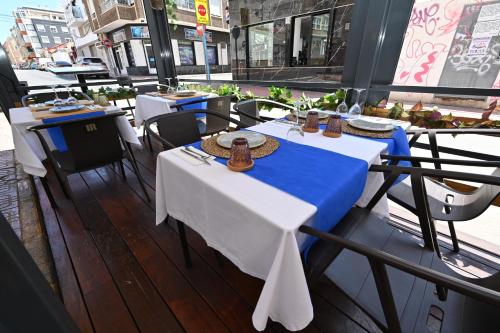 two tables in a restaurant with blue and white tables at HB Torrevieja in Torrevieja