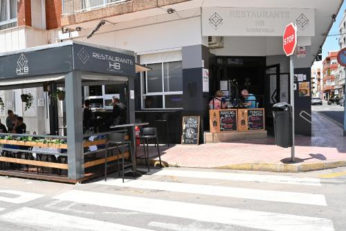 a store on a city street with a stop sign at HB Torrevieja in Torrevieja