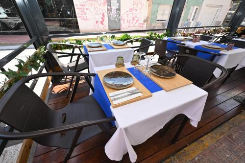 a table with white tables and chairs in a restaurant at HB Torrevieja in Torrevieja