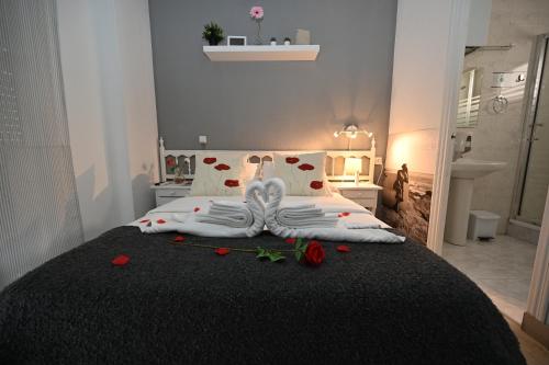 a bedroom with a bed with roses on it at HB Torrevieja in Torrevieja