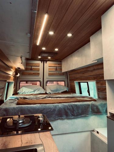 a bedroom with two beds and a table in it at best camper van in tbilisi in Tbilisi City