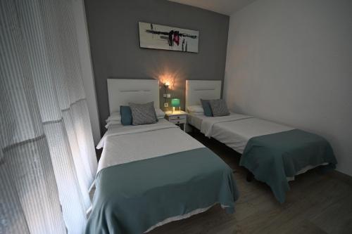 a room with two beds in a room at HB Torrevieja in Torrevieja
