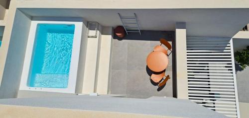 a model of a simpsons house with a swimming pool at Neo Suites in Fira
