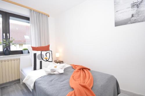 a bedroom with a bed with an orange towel on it at GUN02-RI Apartment in Haundorf in Haundorf