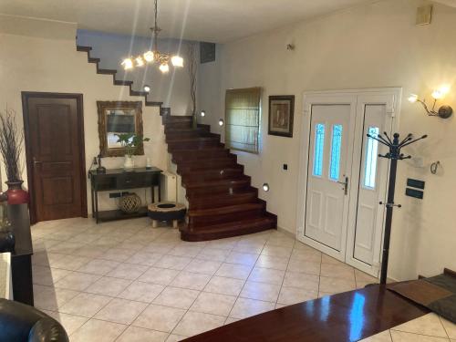 a living room with a staircase in a house at VILLA MARIA in Kanálion