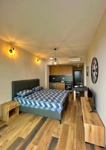 a bedroom with a large bed and a kitchen at Sea & Sky Apartments in Budva