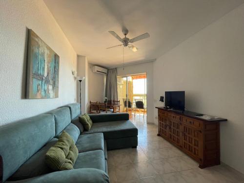 a living room with a couch and a flat screen tv at Apartamentos Apal Chinasol in Almuñécar