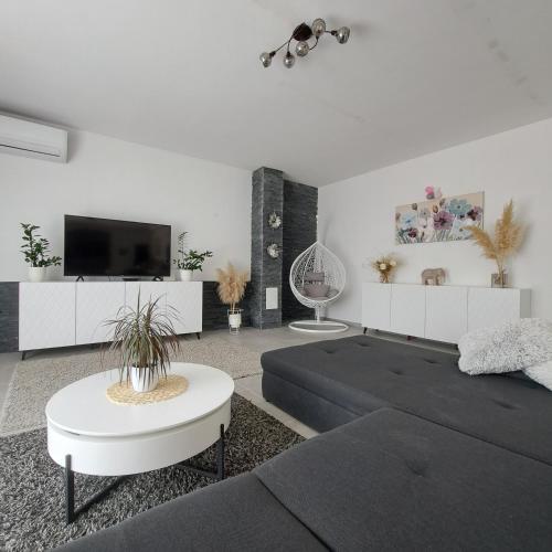 a living room with a couch and a tv at Villa Rita in Orebić