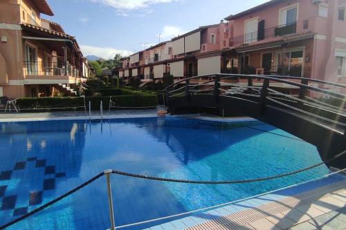 a large swimming pool with a bridge in a building at Luxury Beach House 3 Br, AC in Selianitika