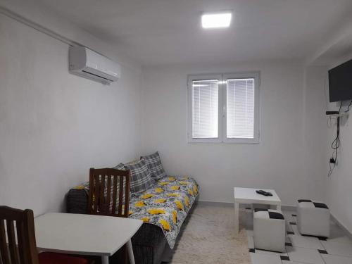 a living room with a couch and a window at Apartments 64 in Star Dojran