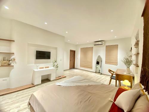 a bedroom with a bed and a desk and a tv at Sushi House Ba Dinh homestay alley38 Hang Bun in Hanoi