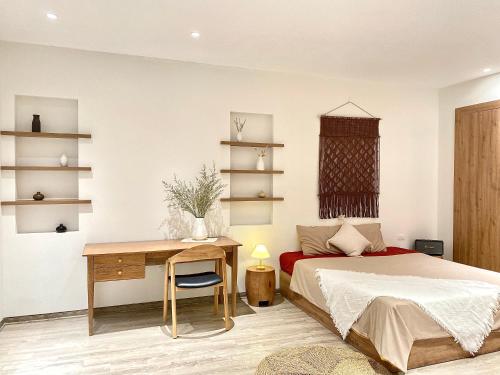 a bedroom with a bed and a desk and a desk at Sushi House Ba Dinh homestay alley38 Hang Bun in Hanoi