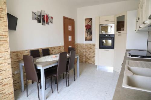 a kitchen and dining room with a table and chairs at Due minuti dal mare con Balcone Vista Mare in Tropea