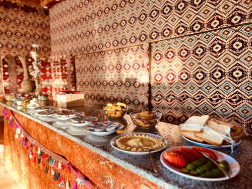 a buffet with many dishes of food on a counter at Salameh's Bedouin Camp in Wadi Rum