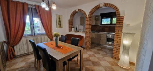 a kitchen and dining room with a table and chairs at Apartments Fantazija Rovinj with a covered parking space in Rovinj