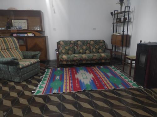 a living room with a couch and a rug at Casa Carolina in Surano