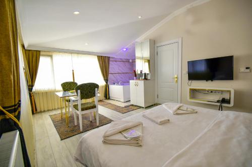 a hotel room with a bed and a television at LOCA Suit LİFE AİRPORT HOTEL in Istanbul