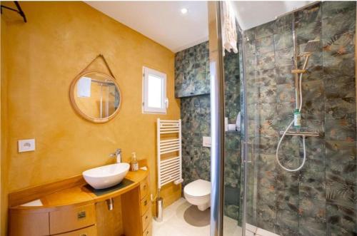 a bathroom with a toilet and a sink and a shower at L'ESCAPADE in Cannes
