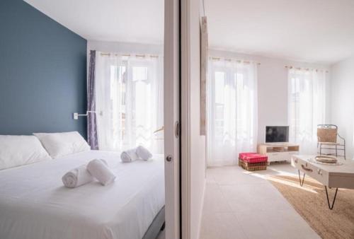 a bedroom with a white bed with towels on it at L'ESCAPADE in Cannes