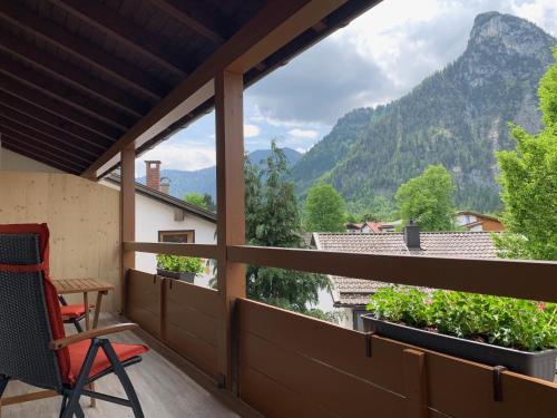 a room with a balcony with a view of mountains at Zum Turm - Apartments und Gästezimmer in Oberammergau