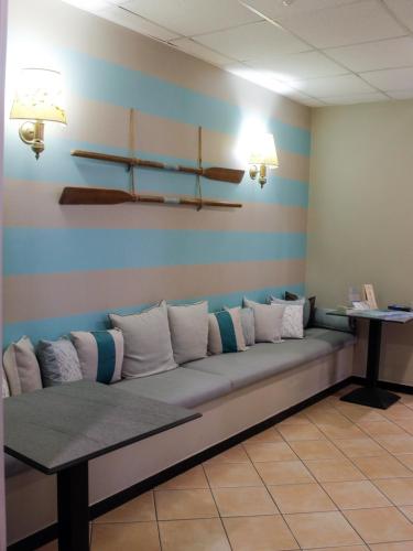a couch in a waiting room with pillows on it at La Camogliese Hotel B&B in Camogli