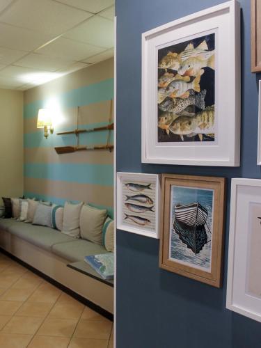 a waiting room with a couch and pictures on the wall at La Camogliese Hotel B&B in Camogli