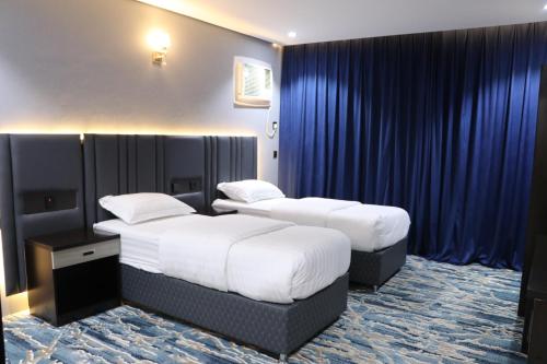Postel nebo postele na pokoji v ubytování فندق قمم بارك Qimam Park Hotel 4