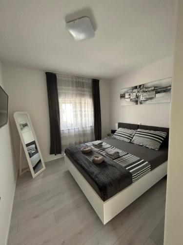 a bedroom with a large bed and a window at Apartman Petra in Vir