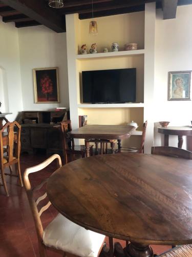 a dining room with a large wooden table and chairs at Podere La Quercia in San Gimignano