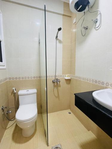 a bathroom with a toilet and a sink at Husin Al Khaleej Hotel Apartment in Seeb