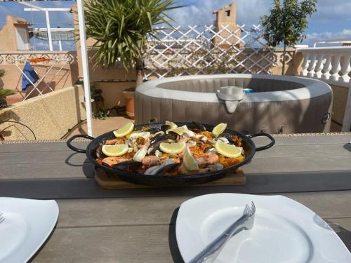 a pan of food sitting on top of a table at Apartament La Mata Torrevieja in Torrevieja