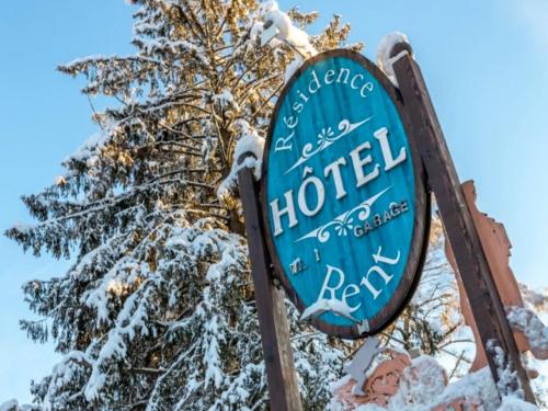 a sign for a hotel in the snow at Résidence Hôtel Rent - Megève Centre in Megève