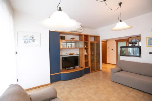 a living room with a couch and a television at Mirea's Rooms in Ascoli Piceno