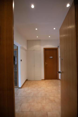 an empty room with a door and a hallway at Mirea's Rooms in Ascoli Piceno