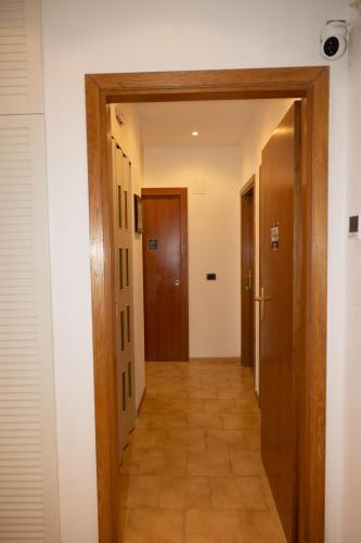 a hallway leading to a room with two doors at Mirea's Rooms in Ascoli Piceno