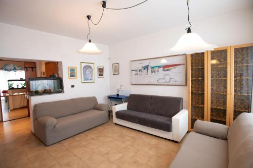 a living room with two couches and a tv at Mirea's Rooms in Ascoli Piceno