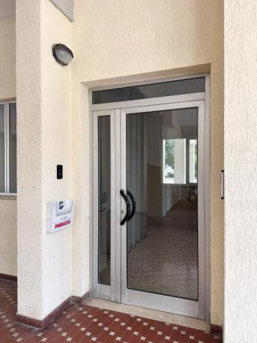 a glass door of a building with a sign on it at Mirea's Rooms in Ascoli Piceno