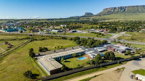 an aerial view of a building in a field with a road at African Sky Harrismith Inn in Harrismith