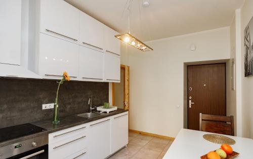 a kitchen with white cabinets and a white counter top at Modern Cozy 1BR apartment in Quiet center of Riga in Rīga