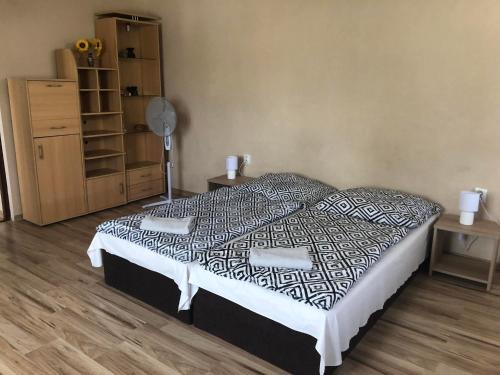 a bedroom with a bed and a wooden floor at Ubytovanie Toscana in Vyšné Revištia
