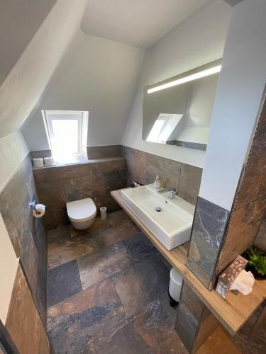 a bathroom with a sink and a toilet at Hotel garni "Café im Hamm" in Zell an der Mosel