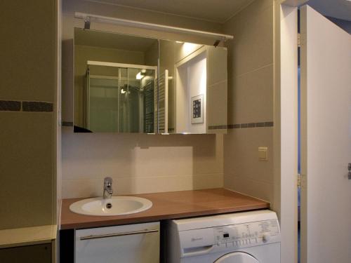 y baño con lavabo y espejo. en Caracas 0102 ideal holiday apartment near the sea, en De Haan