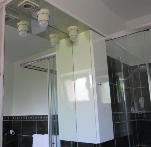 a bathroom with a white cabinet and a mirror at Split Apartments 1-2 in Split