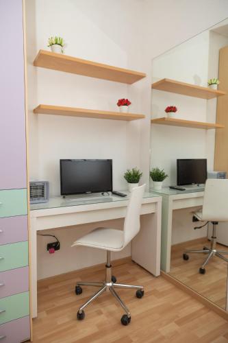 an office with a desk with a computer and two chairs at Mirea's Rooms in Ascoli Piceno