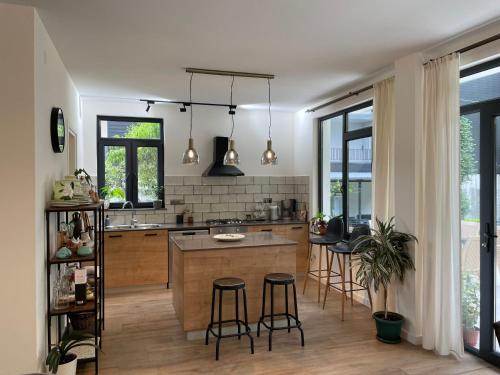 a kitchen with a island with bar stools at Villa Mountview in Gonio