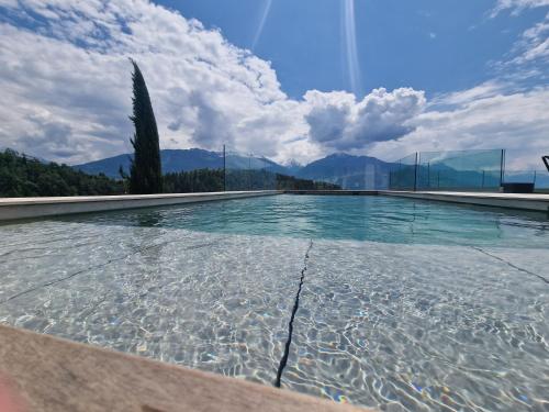 a swimming pool with a view of the mountains at Bella Flocon appartements min 2 Nights Special weekly and monthly prices in Savièse