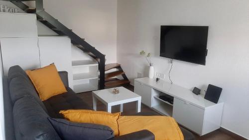 a living room with a couch and a flat screen tv at Apartma Lima in Ankaran